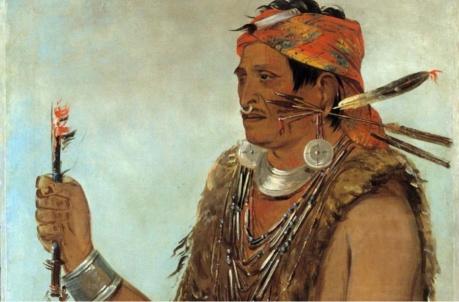 George Catlin's oil painting depicts Tenskwatawa wearing a kerchief atop shorn hair. He has a ring in his nose and feathers through his left ear lobe. He wears multiple strands of beads and silver, and what appears to be animal fur with the claws still attached. Both arms also have thick silver arm and wrist bands. In his right hand, he holds ‘medicine fire,’ and his ‘sacred string of beads’ in the other.