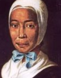 Moravian Evangelist Rebbeca Protten is shown wearing a white bonnet tied with a blue ribbon, a white apron over a black dress. Protten converted hundreds of enslaved people on St. Thomas Island.