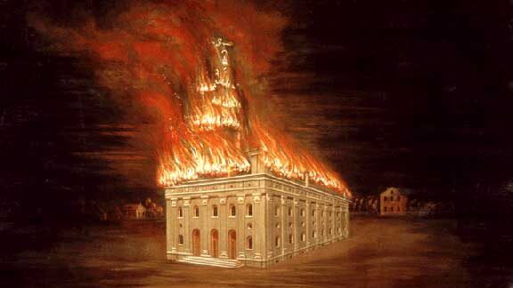 Mormon Nauvoo Temple's entire roof is on fire in this depiction of the 1848 arson fire. The temple is a large, white stone structure with arched windows and doors. Surrounding the temple is darkness, and in the background are homes.