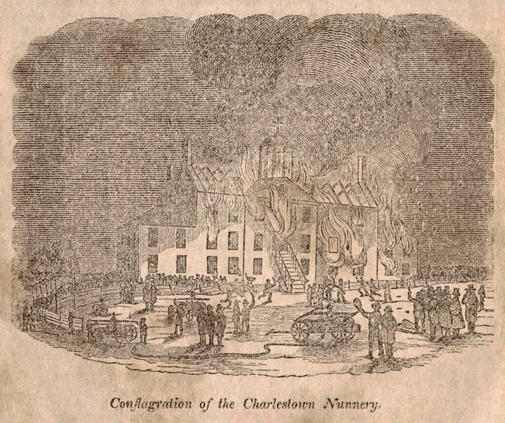 The Ursuline Convent Nunnery burns down in the background while firefighters with wagons of water attempt to put it out. People line the fences, and men in jackets and top hats stand by on the right. Across the bottom of the image is "Conflagration of the Charlestown Nunnery." This illustration highlights the extreme anti-Catholic sentiment in New England.