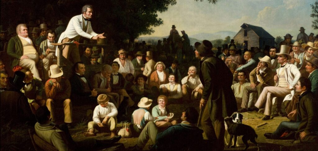 This engraving by George Caleb Bingham, 1853, shows a politician on the back left delivering an oration to the "common man" while standing on a stump, hence the title, "Stump Speaking." Men of various backgrounds and dress are seated listening to the speaker. In the background, a large tree is behind the speaker and to the right in the back is a barn. 
