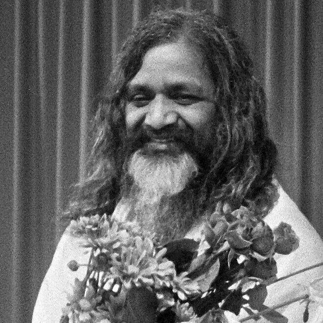 Indian Maharishi (great seer) Mahesh Yogi is pictured with long hair and beard, wearing a garland of flowers and a white tunic. He promoted transcendental meditation in the 1950s with world tours in 1958