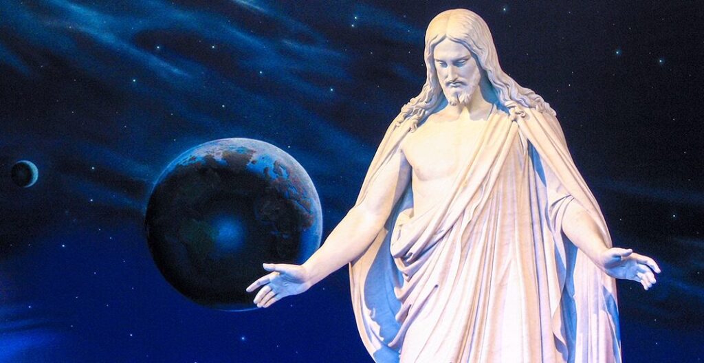 A statue depicting Jesus Christ with outstretched arms is shown in the foreground on the right. In the background is a picture of planets with Earth in the center, stars, and the night sky in a rich blue hue.